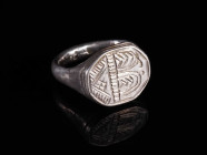 A LATE MEDIEVAL SILVER RING WITH ORNAMENTAL DECORATION Circa 15th century AD. With an octagonal bezel with engraved design. Ring size 55 (EU)

Ex pr...