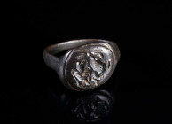 A BYZANTINE BRONZE RING WITH EAGLE AND LION Circa 6th-9th century AD. With an oval bezel engraved with a standing eagle and a prancing lion. Ring size...