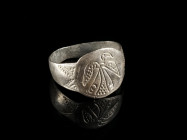 A MEDIEVAL SILVER RING WITH AN EAGLE Circa 9th-10th century AD. Oval bezel with an engraved eagle. Ring size 60 (EU)

Ex private collection, acquire...