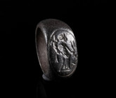 A ROMAN BRONZE RING DEPICTING THE GODDESS FORTUNA Circa 2nd-3rd century AD. Ring with offset oval bezel showing Fortuna right with cornucopia, rudder,...