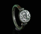 A LATE ROMAN BRONZE RING WITH A LION Circa 4th century AD. Ring with round bezel depicting a prancing lion(?). Ring size 63 (EU)

Ex private collect...