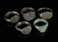 A GROUP OF FIVE MEDIEVAL/EARLY MODERN BRONZE RINGS Circa 12th-16th century AD. Small rings; all with decorated bezel. Ring sizes 36-46 (EU)

Ex priv...