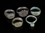A GROUP OF FIVE MEDIEVAL/EARLY MODERN BRONZE RINGS Circa 12th-16th century AD. Small rings; all with decorated bezel. Ring sizes 35-44 (EU)

Ex priv...