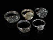 A GROUP OF FIVE MEDIEVAL/EARLY MODERN BRONZE RINGS Circa 12th-16th century AD. Small rings; all with decorated bezel. Ring sizes 38-44 (EU)

Ex priv...