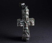 A BYZANTINE BRONZE RELIQUARY CROSS WITH CHRIST AND MARY Circa 10th-12th century AD. Reliquary cross (enkolpion) depicting the crucifixion on the front...
