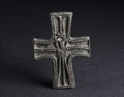 A BYZANTINE BRONZE CROSS APPLIQUE WITH CHRIST CRUCIFIED Circa 9th-12th century AD. Cross decorated with a design of braided bands, depicting Christ in...