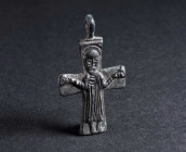 A BYZANTINE BRONZE CROSS PENDANT WITH A SAINT Circa 9th-11th century AD. Depicting a Saint with his hands upraised in prayer. H 37 mm

Ex private co...