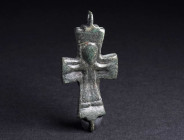 A SMALL BYZANTINE BRONZE RELIQUARY CROSS Circa 10th-12th century AD. One half of a reliquary cross (enkolpion) depicting Christ crucified. H 48 mm

...