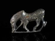 A ROMAN BRONZE BROOCH OF A GRAZING HORSE Circa 2nd-3rd century AD. Horse to left on horizontal base. Part of tail and pin missing. L 33 mm

Private ...