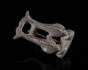 A ROMAN BRONZE DOUBLE DOLPHIN BROOCH Circa 2nd-3rd century AD. The bow in the shape of two stylised dolphins; with hinged pin (pin restored); pitted s...