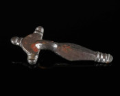 A MIGRATION PERIOD/GEPIDIC BRONZE BROOCH Circa 5th century AD. Bow brooch with semicircular head plate with three knobs and rhombic foot terminating i...