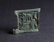 A BYZANTINE BRONZE BELT BUCKLE WITH A GRIFFIN Circa 9th-11th century AD. Square plate from a belt-buckle; in relief, a griffin striding left; two atta...