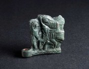 A BYZANTINE BRONZE BELT BUCKLE WITH A HUNTING SCENE Circa 9th-11th century AD. Square plate from a belt-buckle; in relief, a hunter on horseback with ...