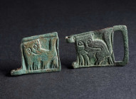 TWO BYZANTINE BRONZE BELT BUCKLES WITH LIONS Circa 9th-11th century AD. Two square plates from belt-buckles; in relief, highly stylised lions; attachm...
