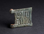 A BYZANTINE BRONZE BELT BUCKLE WITH AN ANIMAL Circa 9th-11th century AD. Square plate from a belt-buckle; in relief, a highly stylised animal represen...