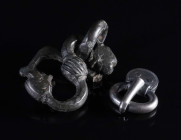 AN EARLY MEDIEVAL AND A POST MEDIEVAL BUCKLE Circa 5th century AD, and 16th-17th century AD. A small migration period silver buckle with decorated ova...