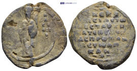 Byzantine Lead Seal (33mm, 17.9 gr) Obv: Saint Basil, standing facing, nimbate, raising his right hand in benediction and holding a book of Gospels in...