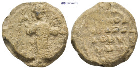Byzantine Lead Seal (21mm, 9.4 gr) Obv: Michael standing facing, holding trefoil scepter in his right hand and globe in his left. Rev: Legend four lin...