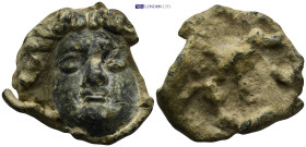 A bronze face of the Gorgon Medusa with finely modelled hair swept away from the face. (44mm, 57.0 g)