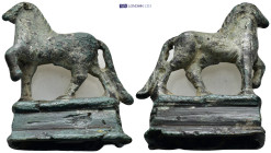 A bronze figure of an advancing horse with foreleg raised on a socle base with short splayed legs. (55mm, 81.4 g)