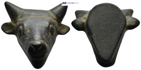 A bronze fitting in the form of a bull's head with elongated eyes and flaring nostrils; two horns absent; two holes to rear. (32mm, 75.0 g)