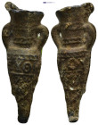 Amphora-Shaped Pilgrim's Ampulla. A lead ampulla in the shape of an amphora with wide neck, small handles to the shoulder, conical body tapering to a ...