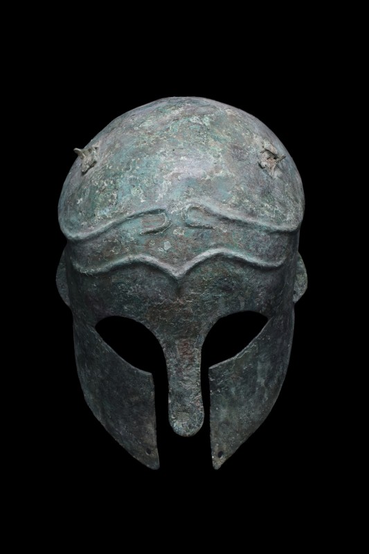 RARE GREEK CORINTHIAN BRONZE HELMET

Ca. 600 BC
A bronze combat helmet of arc...