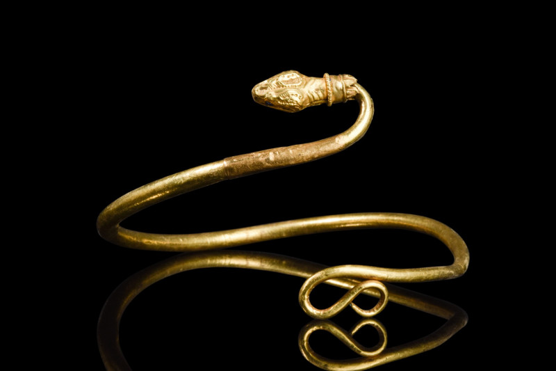 HEAVY PTOLEMAIC GOLD ARM RING

 Egypt, Ca. 525-30 BC
 A heavy gold spiral sna...