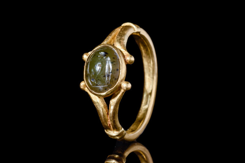 ROMAN FAUSTULUS INTAGLIO IN GOLD RING

 Ca. 100 AD
 An oval-shaped green jasp...