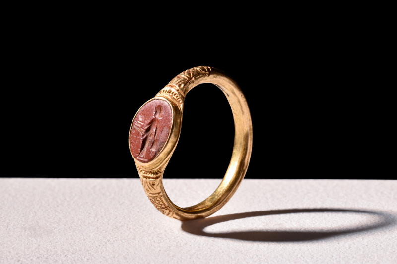 ROMAN GOLD RING WITH JASPER INTAGLIO OF PRIAPUS

 Ca. 100 AD
 A gold finger r...