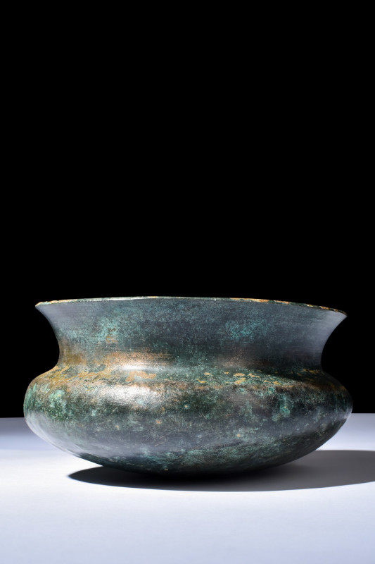 ETRUSCAN BRONZE VESSEL

 Ca. 700-600 BC
 A bronze vessel with a broad neck an...