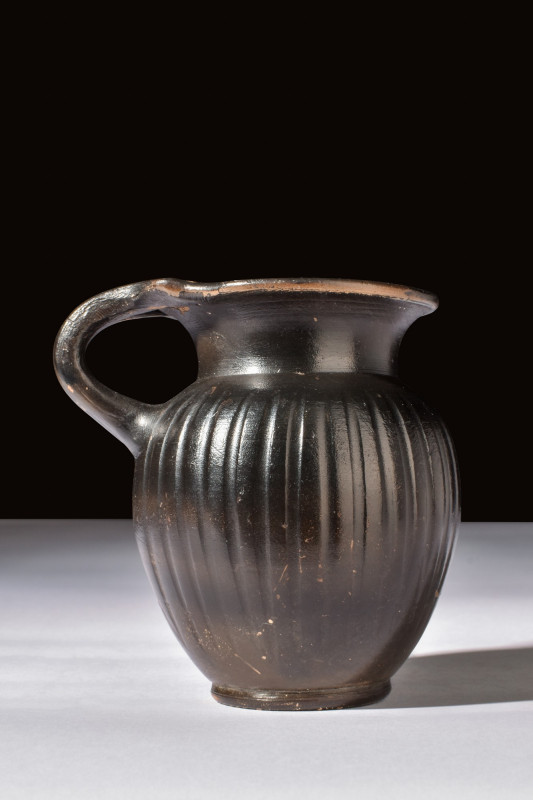 APULIAN BLACK-GLAZED OLPE WITH HANDLE

 Ca. 400-300 BC
 A black glazed olpe f...