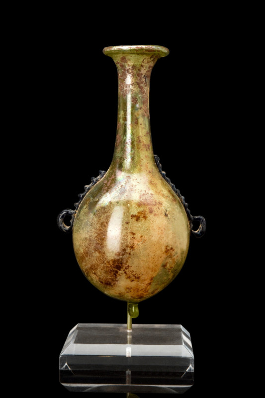 ROMAN GLASS FLASK WITH CRIMPED TRAILING

 Ca. 300-400 AD
 A greenish-yellow g...