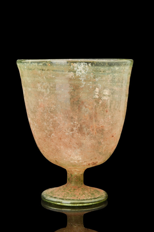 ROMAN GLASS FOOTED CHALICE

 Ca. 300 AD
 A light green glass chalice with a g...