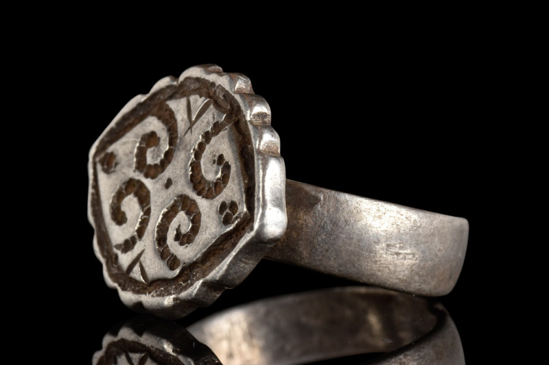 BYZANTINE SILVER RING

 Ca. 800 AD
 A silver ring with a flat-section hoop an...