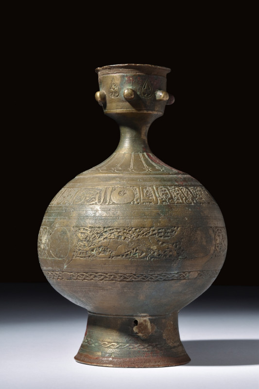 SELJUK BRONZE PERFUME BOTTLE

 Ca. 1000-1100 AD
 A bronze bottle featuring an...