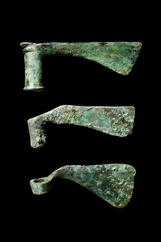 BRONZE AGE GROUP OF THREE AXE HEADS

 Ca. 2000 BC
 A set of three bronze axe ...