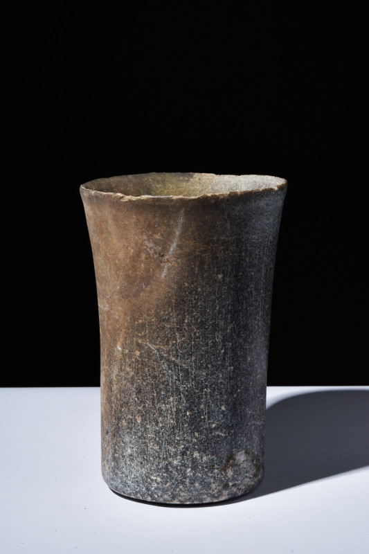 BACTRIAN STONE BEAKER

 Ca. 2000 BC
 A stone beaker of cylindrical shape with...