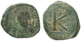 Justinian I, 527-565. Half follis (bronze, 13.81 g, 31 mm), Carthage. D N IVSTINIANVS P P AVC Helmeted and cuirassed facing bust, holding globus cruci...