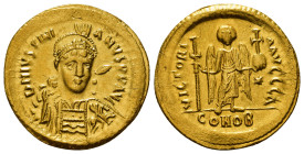 JUSTINIAN I (527-565). GOLD Solidus. Constantinople.
Obv: D N IVSTINIANVS P P AVG.
Helmeted and cuirassed bust facing slightly right, holding spear ...