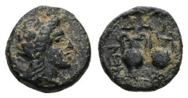 Macedon, Mende. Ae, 2.00 g 12.62 mm. Circa 400-350 BC. 
Obv: Head of Dionysos right, wearing ivy wreath 
Rev: Two amphora. 
Ref: SNG ANS 931-4. 
Near ...