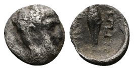 Ionia, Magnesia ad Maeandrum. AR Tetartemorion, 0.15 g 5.39 mm. 400-350 BC. 
Obv: Head of Apollo right.
Rev: [MAΓ] above barley corn, Maeander pattern...