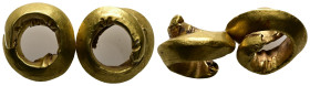 A gold earring. Middle Bronze Age, Southeastern Europe, 16th - 15th century BC.
Two curl rings.
Weight: 10.52 g. 
Diameter: 37.02 mm.