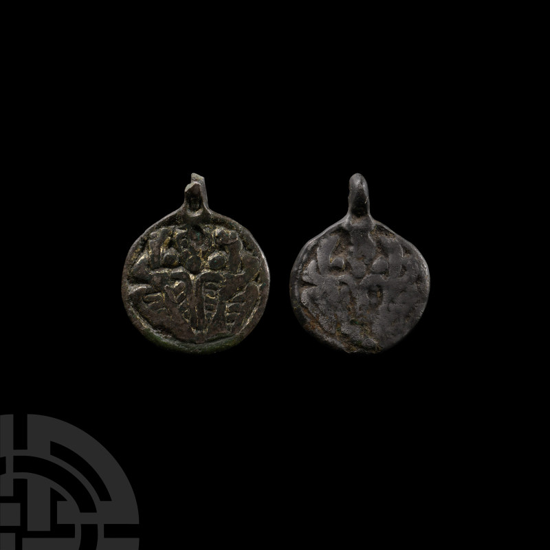 Viking Age Bronze Pendant Group
9th-11th century A.D. Comprising two discoid pe...