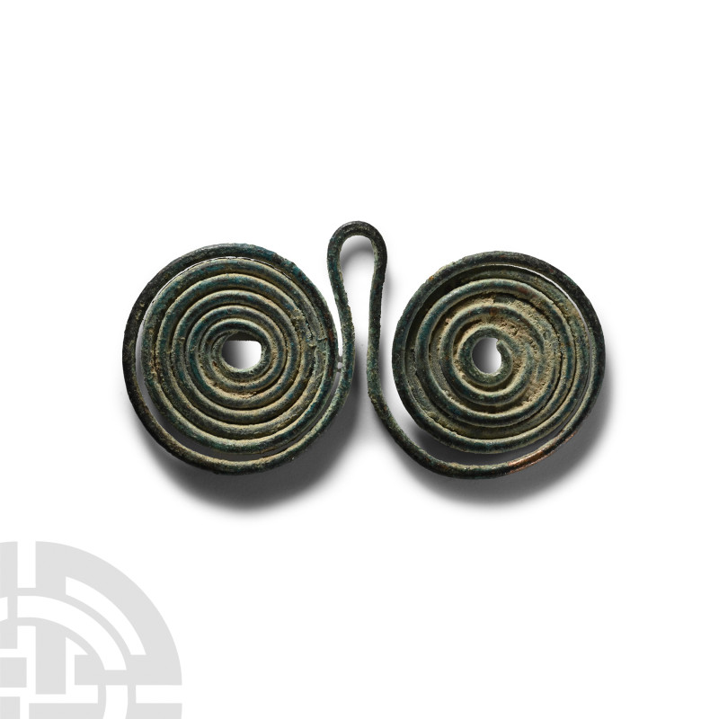 Bronze Age Spectacle Pendant
Circa 10th-6th century B.C. Composed of two coiled...
