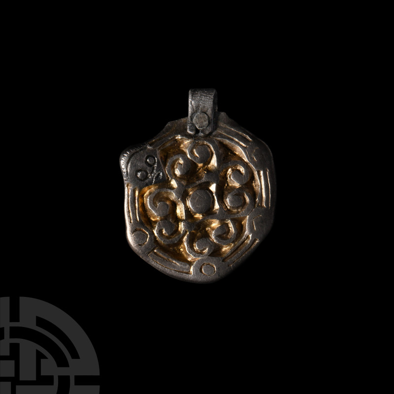 Viking Age Silver-Gilt Pendant with Face
9th-10th century A.D. Displaying scrol...