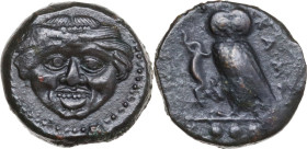 Sicily. Kamarina. AE Tetras, 425-405 BC. Obv. Gorgoneion. Rev. Owl standing left, head facing, wings closed, holding lizard; in exergue, three pellets...