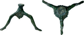 GREEK BRONZE TRIPOD Greek World, c. 4th-3rd century BC. Tripod shaped in three human legs, interspersed with seven-leaf palmette. Lenght: 135 mm.; Hei...