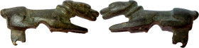 ROMAN DOG FIBULA Roman period, c. 50-200 AD. Roman bronze fibula in the shape of a dog. Dimensions: 41x18 mm. Pin missing, otherwise intact.