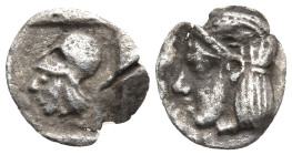Asia Minor, uncertain mint AR Tetartemorion. Circa 4th century BC. Archaic head of Apollo left, wearing tainia / Helmeted head of Athena left within i...